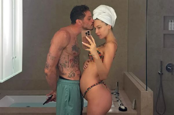 Pete Davidson lovingly kissing his pregnant girlfriend Elsie Hewitt on forehead